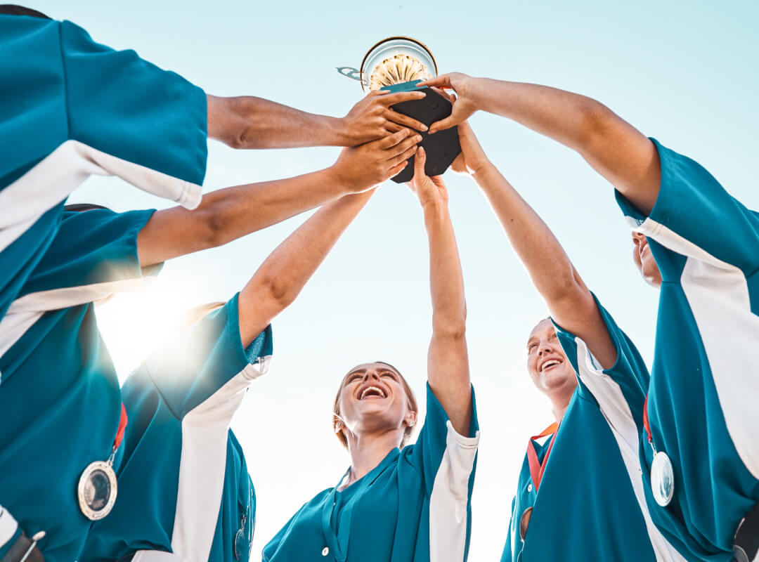 A group of baseball players holding up a trophy.